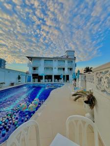 a resort with a swimming pool and a building at Juan de la vega in La Vega