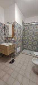 a bathroom with a sink and a toilet at La Casa sulla Piazza in Sciacca