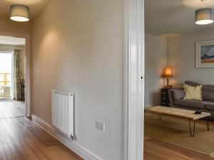 a living room with a couch and a table at Burrows Ridge in Appledore