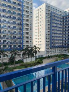 a view of two large buildings from a balcony at Stay Cay Affordable Price by -Mang Domeng in Manila