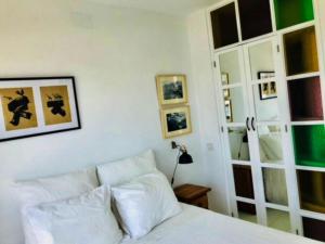 a bedroom with a white bed and a mirror at One bedroom appartement with wifi at Cartagena in Cabo de Palos