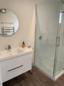 a bathroom with a sink and a shower at Kingston TOP 10 Holiday Park in Kingston