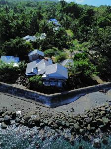 an aerial view of a house next to the water at Shey's Travellers Inn in Mambajao
