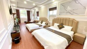Postel nebo postele na pokoji v ubytování BÔNG SEN HOTEL CÔN ĐẢO