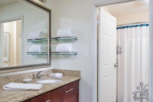 a bathroom with a sink and a mirror at Residence Inn by Marriott Houston The Woodlands/Lake Front Circle in The Woodlands