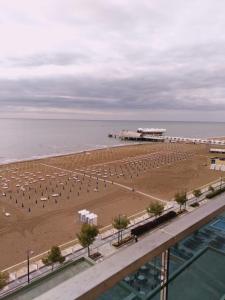 a view of a beach with umbrellas and the ocean at Hotel Columbus in Lignano Sabbiadoro