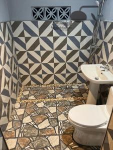 a bathroom with a toilet and a sink at The Beach House Long Beach in New Agutaya