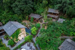 an overhead view of a house with a garden and trees at Yangshuo Ancient Garden Boutique Hotel in Yangshuo