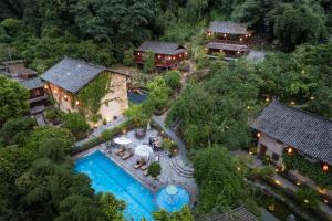 an aerial view of a resort with a swimming pool at Yangshuo Ancient Garden Boutique Hotel in Yangshuo