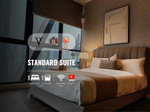 a bedroom with a bed with a standard suite sign on it at Scarletz Suites KLCC by De Harlequins Guesthouse in Kuala Lumpur