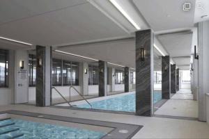 a large swimming pool in a building at 660sqf Condo by Lake close to Airport, Parking! in Toronto