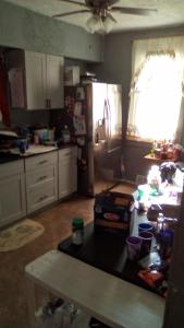 a kitchen with a table in the middle of it at Mountain house in West Homestead