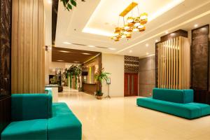 a lobby with blue couches in a building at Bluesea 1 BR Superior Room ZN25 in Senggigi  +16 photos