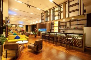 a living room with a yellow couch and chairs at Bluesea 1 BR Superior Room ZN25 in Senggigi 