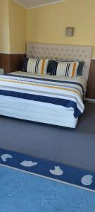 a bedroom with a bed with a blue rug with cats on it at Bed and Breakfast Happy Home Taupo Accommodation in Taupo