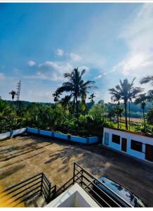 a view from the roof of a building with palm trees at Streaming Valley Coffee Estate Stay in Madikeri