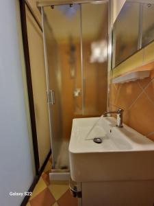 a bathroom with a sink and a shower at Sikelia House Cefalù in Cefalù