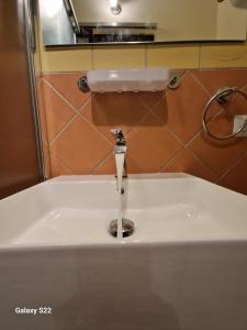 a sink in a bathroom with a water fountain at Sikelia House Cefalù in Cefalù
