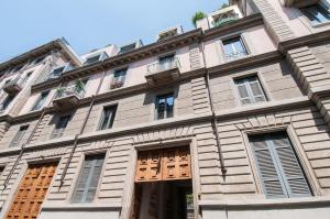 a large building with wooden doors and windows at Brera Prestige B&B in Milan