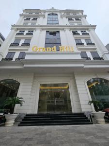 a grand hill building with a sign on it at Grand Hill Hotel & Apartment in Hai Phong