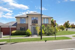 a house on the side of a street with a street sign at Deluxe Family Montpellier Gardens Estate - Burwood in Burwood