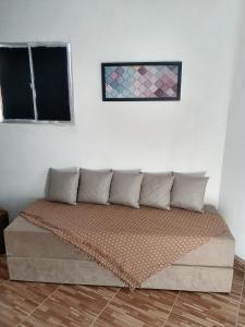 a bed in a room with a wall at APÊ AVENIDA - BONITO/PE in Bonito