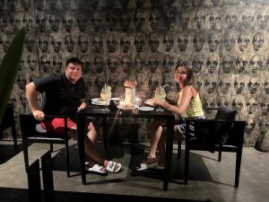 a man and a woman sitting at a table at Saffron Robes Living in Hikkaduwa