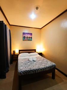 a bedroom with a bed with two pillows at Softstone resort in Panglao Island