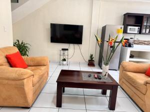 a living room with two couches and a coffee table at Chalchuapa, Santa Ana La Casa de Sussy, El Salvador in Chalchuapa
