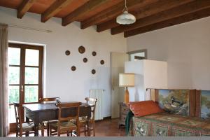 a living room with a table and a dining room at Cascina Delle Rose in Barbaresco