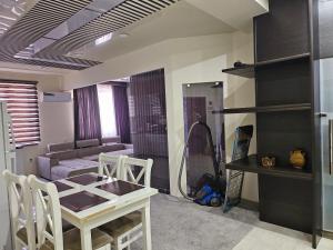sala de estar con mesa y sofá en Аппартаменты Rohat en Samarcanda