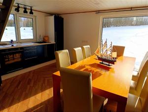 a dining room with a wooden table with a model boat on it at Seto Kapten in Meremäe
