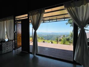 a room with a large window with a view at Star Hill Dak Nong Retreat in Gia Nghĩa