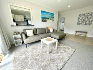 a living room with a couch and a table at The Whitehouse in Emu Bay