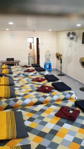 a room with a patterned floor with many pillows on it at DANDELI CROCODILE EDGE HOME STAY in Dandeli