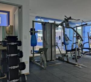 a gym with several tread machines in a room at Tonsupa Diamond Beach in Tonsupa