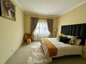 a bedroom with a large bed and a window at Six64 on KINGSWAY B5 in Amanzimtoti