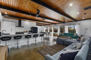 a living room with couches and a bar in a house at NEW - Hilderton on Hogans in Yarrawonga