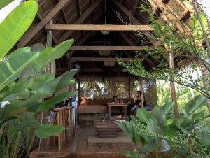 a group of people sitting at a table in a restaurant at Single Fin Siargao in General Luna