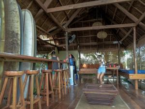 a woman standing in front of a bar at Single Fin Siargao in General Luna