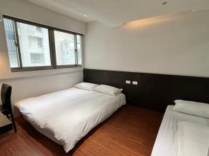 Postel nebo postele na pokoji v ubytování Formosa 101 Taipei Main Branch