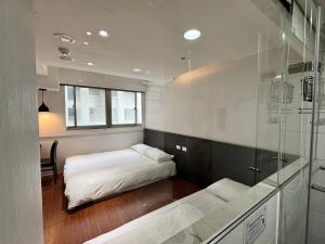 Postel nebo postele na pokoji v ubytování Formosa 101 Taipei Main Branch