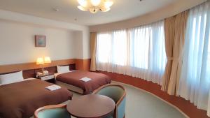 Postel nebo postele na pokoji v ubytování Utazu Grand Hotel