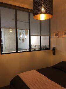 sypialnia z łóżkiem i oknem z oświetleniem w obiekcie Appartement d'une chambre avec wifi a Dijon w mieście Dijon