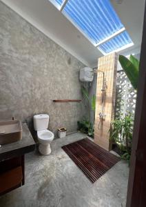 uma casa de banho com um WC e um lavatório em Single Fin Siargao em General Luna