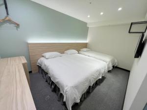 Postel nebo postele na pokoji v ubytování Formosa 101 Taipei Main Branch