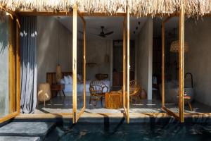 a villa with a swimming pool and a bedroom at Be Zanzibar Boutique Hotel in Mfumbwi