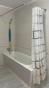 een badkamer met een bad en een douchegordijn bij Luxury-Family-Cottage in Bosteri