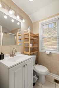 a bathroom with a sink and a toilet and a mirror at Unique home surrounded by nature 7 mins from DC in Arlington