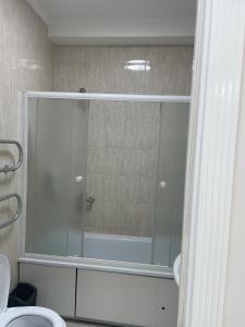 a bathroom with a shower and a bath tub at Bon Mary Hotel in Astana